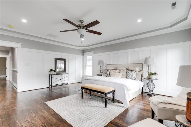 bedroom featuring ceiling fan, ornamental molding, and dark hardwood / wood-style flooring