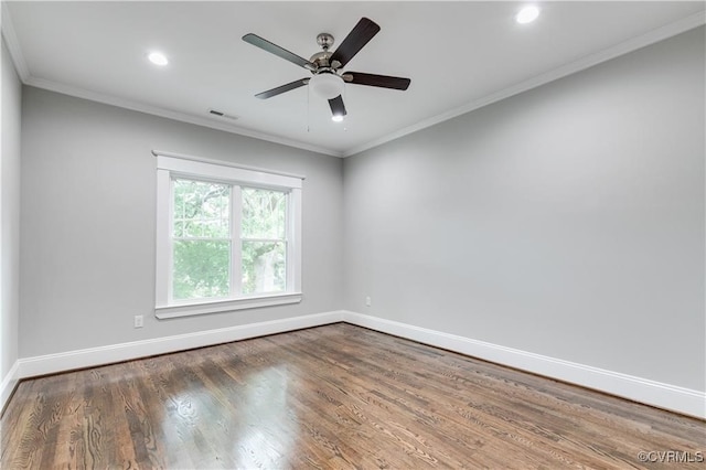 spare room with crown molding, dark hardwood / wood-style floors, and ceiling fan