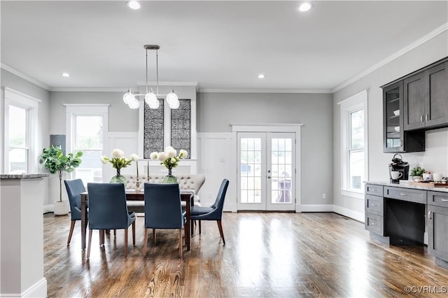 dining room with crown molding, dark hardwood / wood-style floors, and plenty of natural light