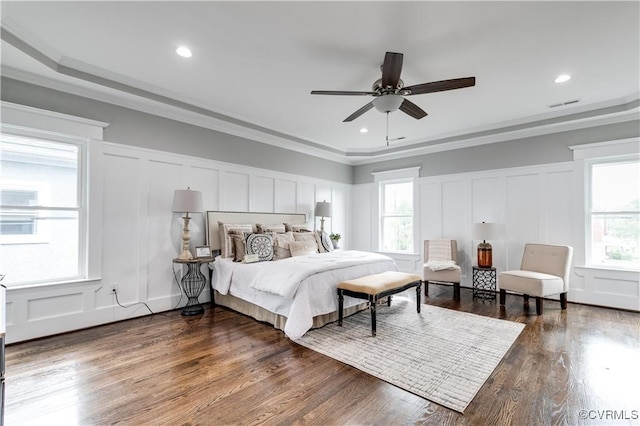 bedroom with crown molding, dark hardwood / wood-style floors, and ceiling fan