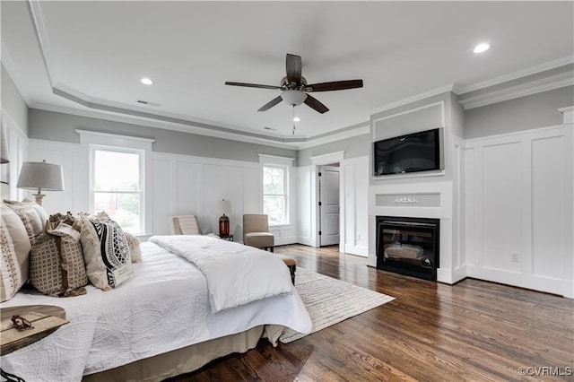 bedroom with crown molding, dark wood-type flooring, and ceiling fan