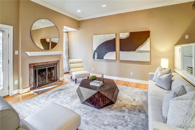 sitting room with crown molding, a high end fireplace, and wood-type flooring