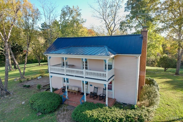 rear view of property with a patio area and a yard