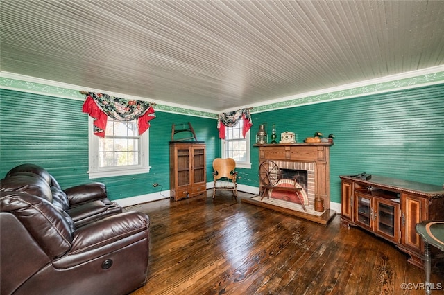 living room featuring hardwood / wood-style floors, a brick fireplace, and crown molding