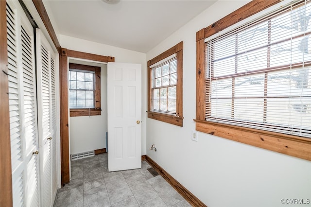 unfurnished bedroom with light tile patterned flooring and multiple windows