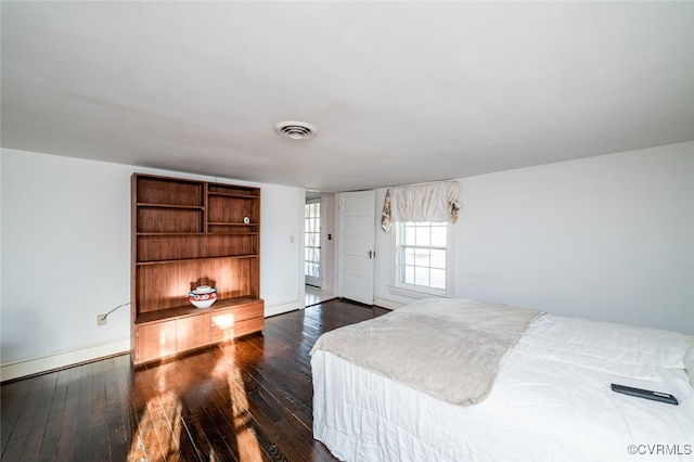 bedroom with dark hardwood / wood-style floors