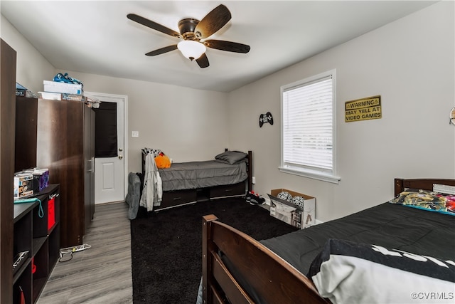 bedroom featuring ceiling fan and hardwood / wood-style flooring