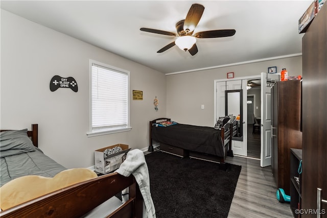 bedroom with a closet, wood-type flooring, and ceiling fan