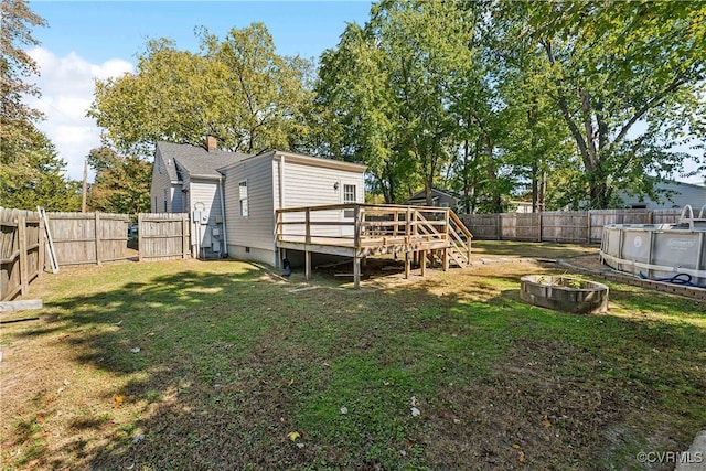 view of yard with a swimming pool side deck