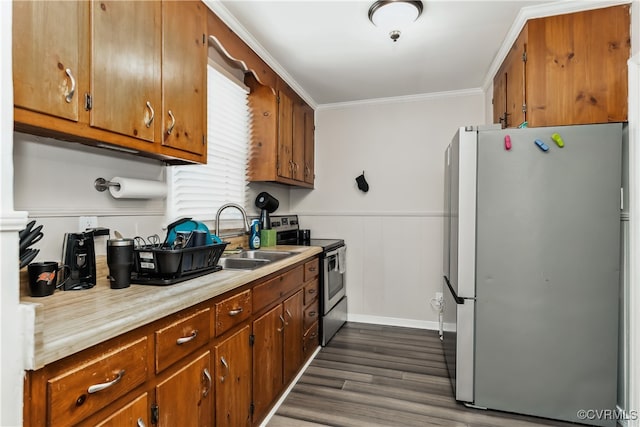 kitchen with appliances with stainless steel finishes, crown molding, sink, and dark wood-type flooring