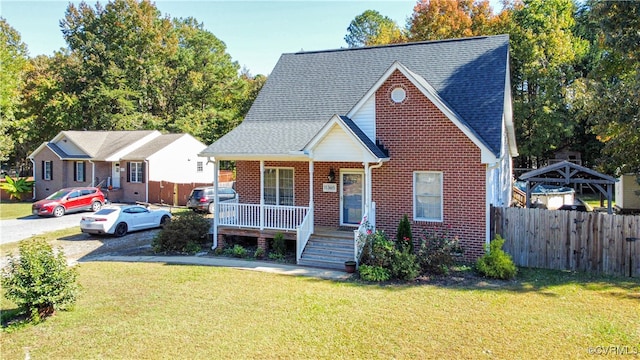 bungalow-style home with covered porch and a front lawn