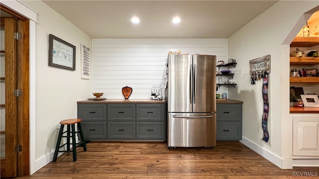 kitchen featuring stainless steel refrigerator, dark hardwood / wood-style floors, and gray cabinets