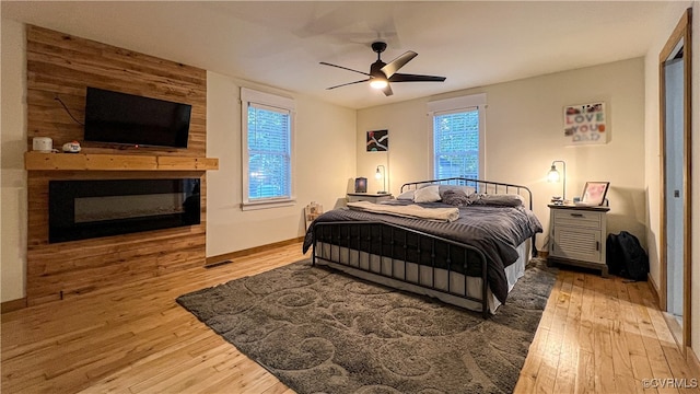 bedroom with hardwood / wood-style floors and ceiling fan