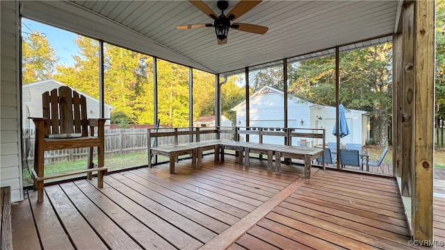 sunroom featuring vaulted ceiling and ceiling fan