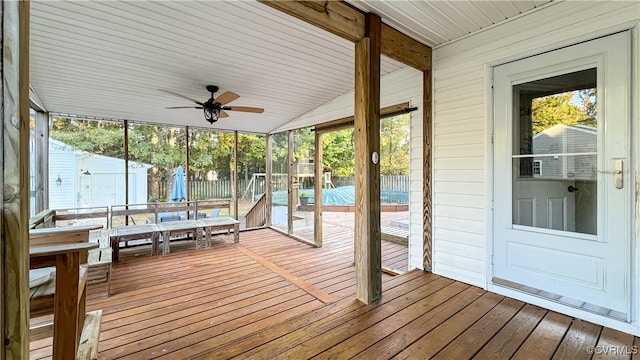 exterior space with ceiling fan and a swimming pool