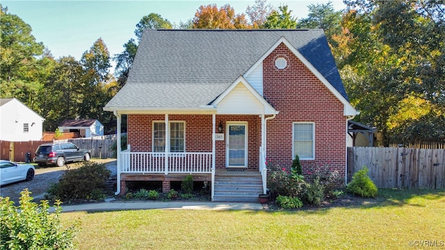 bungalow-style house featuring covered porch and a front lawn