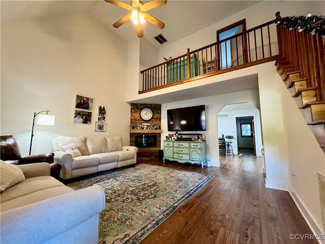 living room with ceiling fan, high vaulted ceiling, and dark hardwood / wood-style flooring