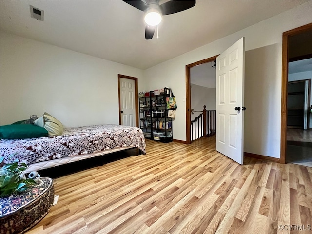 bedroom with light wood-type flooring and ceiling fan