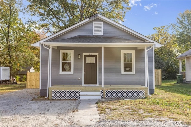 bungalow-style house featuring a front lawn and covered porch