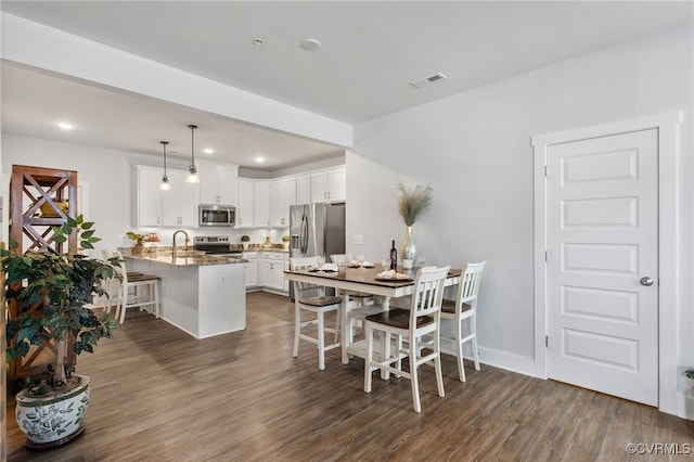 dining space featuring dark wood-type flooring