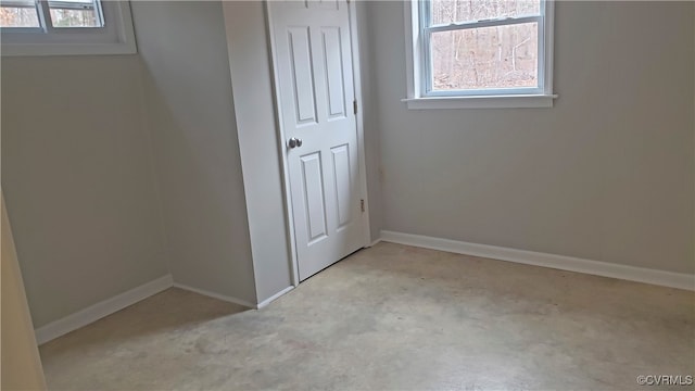 unfurnished room with light colored carpet and plenty of natural light