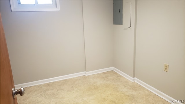 spare room with electric panel and light carpet