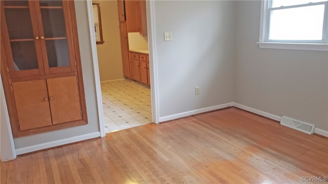 spare room with light hardwood / wood-style floors