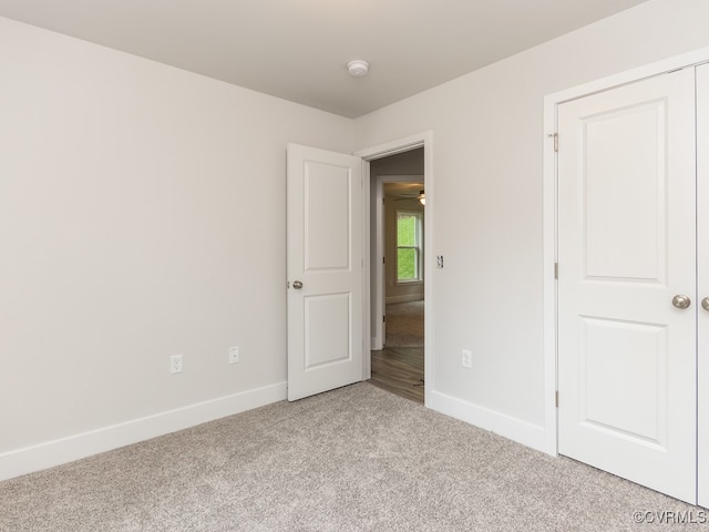 unfurnished room with light colored carpet