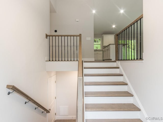 stairway featuring recessed lighting and baseboards