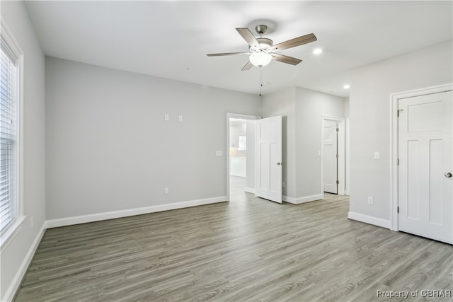 unfurnished bedroom featuring light hardwood / wood-style flooring and ceiling fan