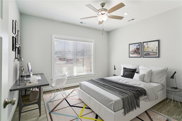 bedroom with hardwood / wood-style flooring and ceiling fan