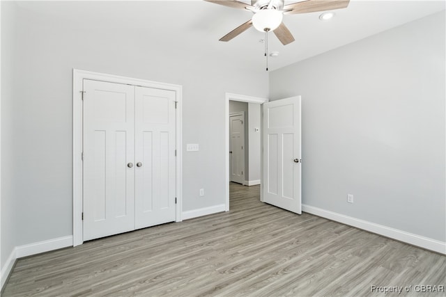 unfurnished bedroom with a closet, light wood-type flooring, and ceiling fan