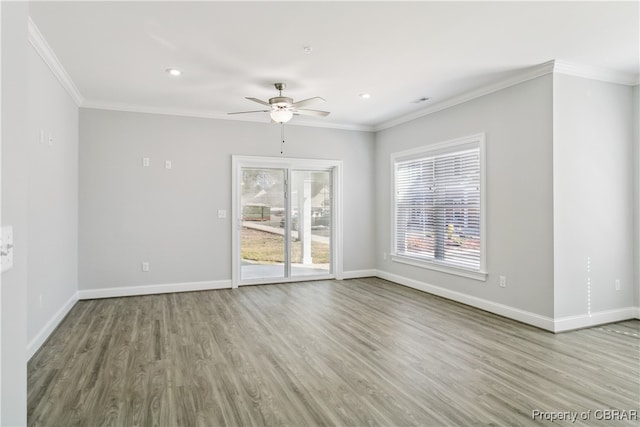 spare room with light hardwood / wood-style floors, ornamental molding, and ceiling fan