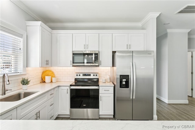 kitchen with white cabinetry, appliances with stainless steel finishes, and sink