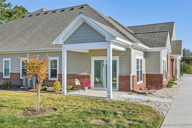 back of house with a lawn and central AC unit