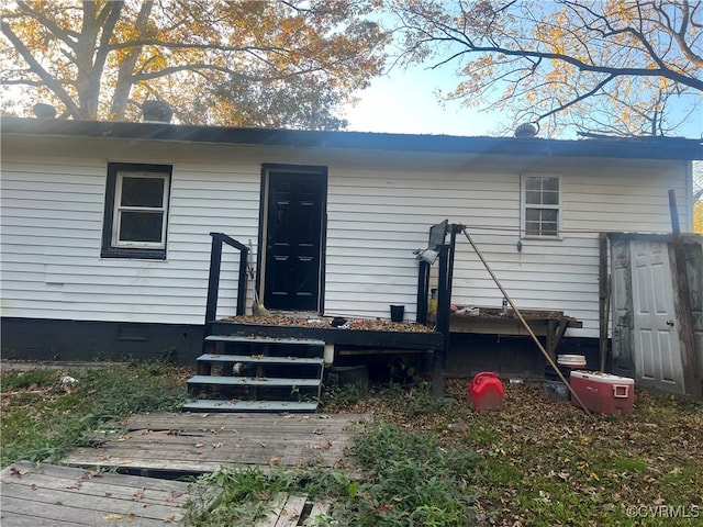 rear view of property featuring a deck