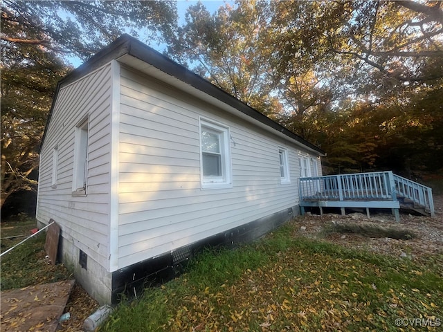 view of side of home with a deck