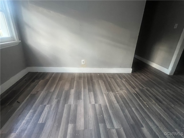 spare room featuring dark wood-type flooring