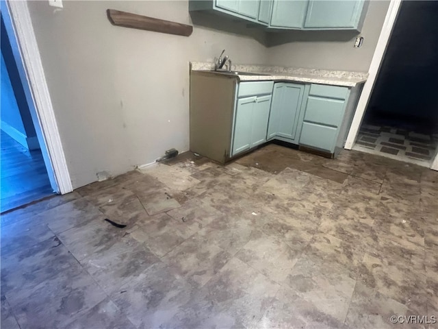 kitchen featuring green cabinets and sink