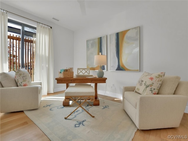 living area with hardwood / wood-style flooring