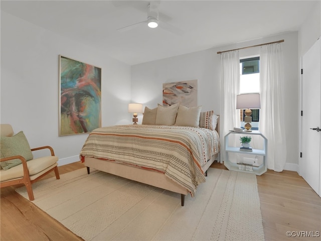 bedroom with ceiling fan and light hardwood / wood-style flooring