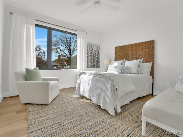 bedroom with ceiling fan and hardwood / wood-style flooring