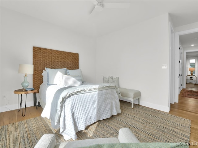 bedroom with ceiling fan and hardwood / wood-style floors