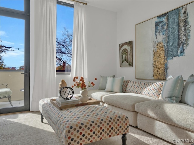 living room featuring light carpet and a wealth of natural light