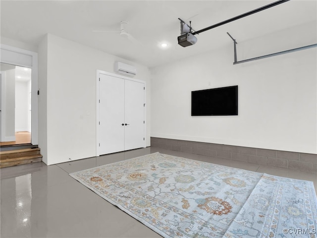 garage featuring a wall mounted air conditioner and a garage door opener