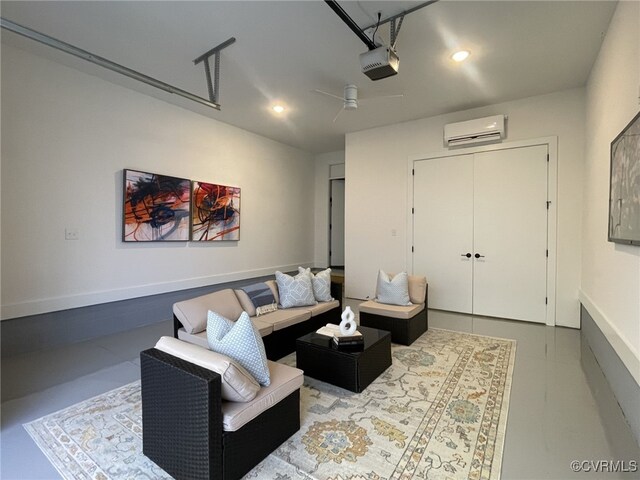 living room with ceiling fan and an AC wall unit