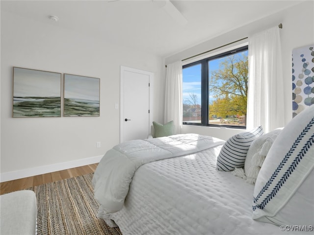 bedroom featuring hardwood / wood-style flooring and ceiling fan