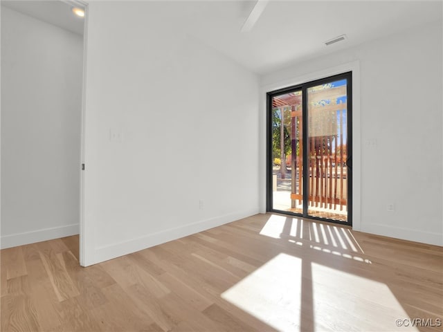 unfurnished room with light wood-type flooring