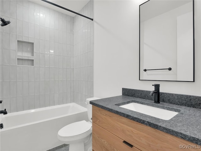 full bathroom featuring toilet, tiled shower / bath combo, and vanity