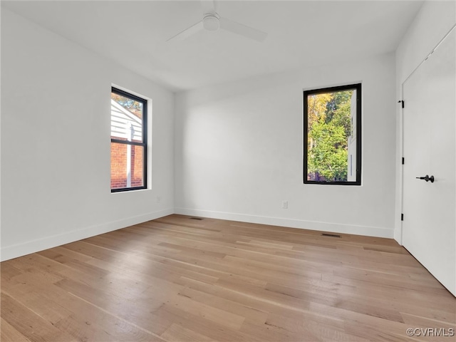 empty room with light hardwood / wood-style floors and ceiling fan